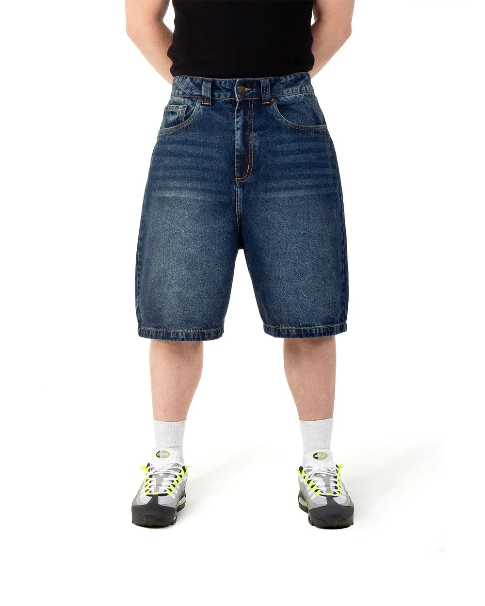 Person wearing blue denim shorts on a white background