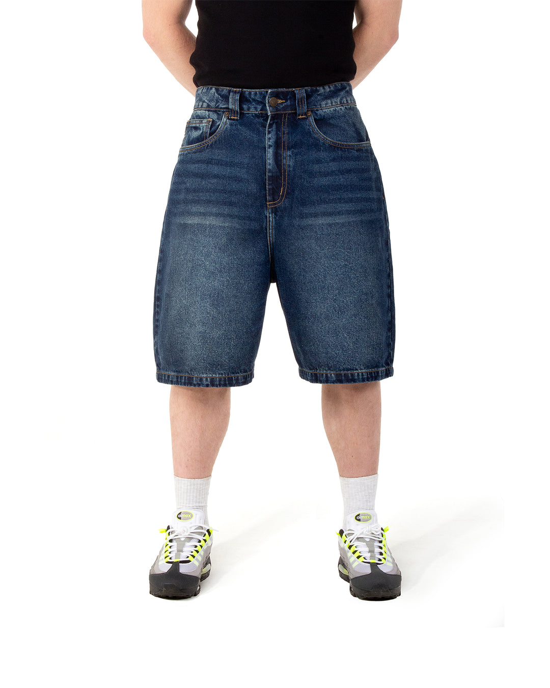 Person wearing blue denim shorts on a white background