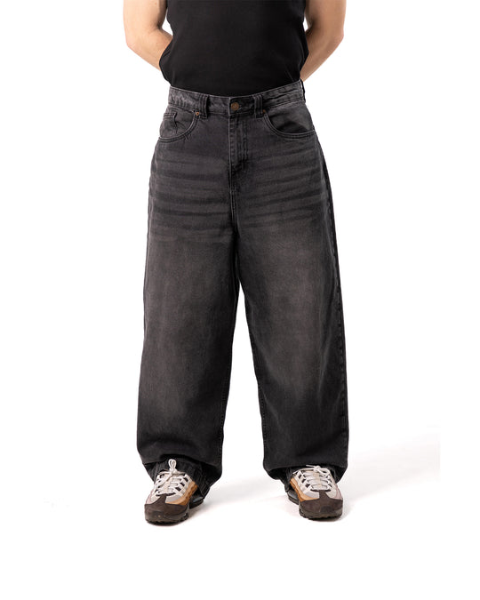Person wearing wide-leg black jeans on a white background