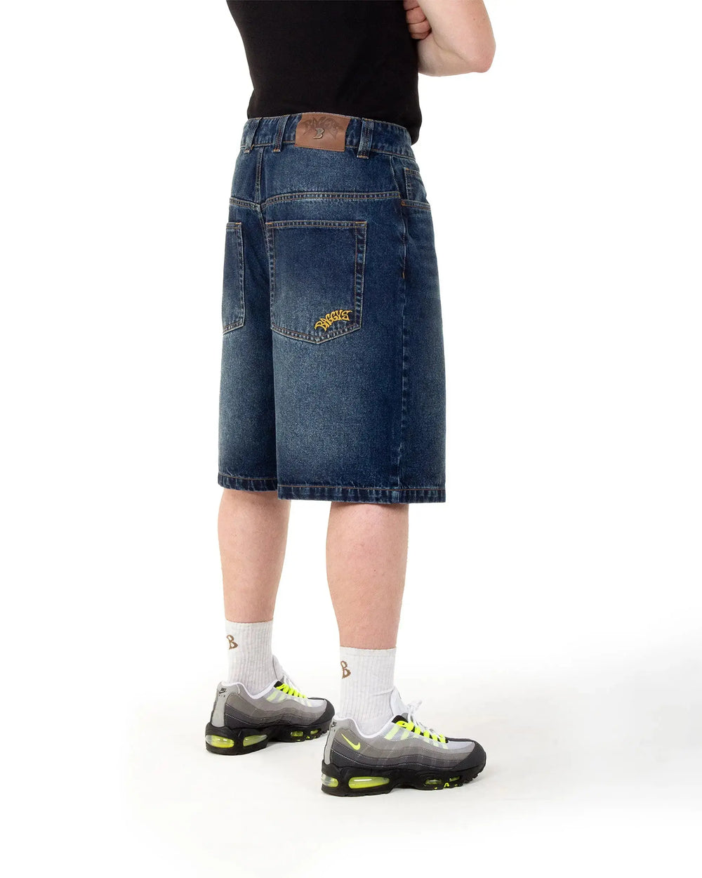Person wearing a blue denim skirt on a white background