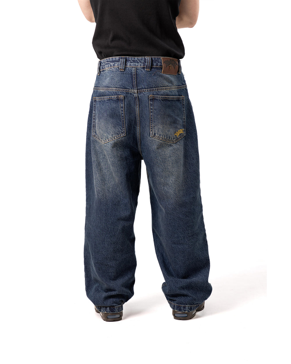 Person wearing blue jeans on a white background