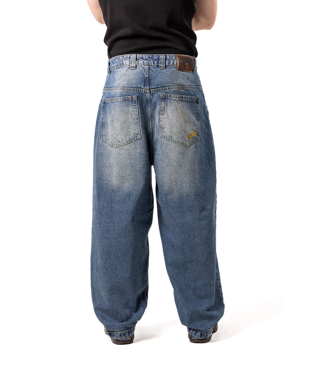 Blue jeans worn by a person on a white background