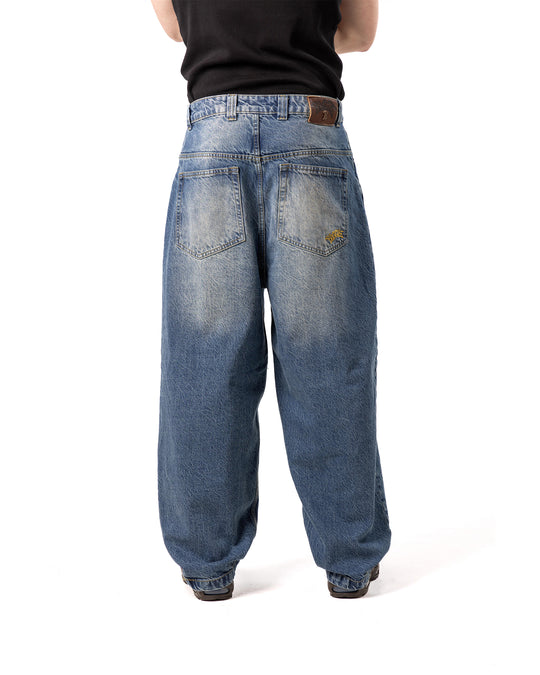Blue jeans worn by a person on a white background